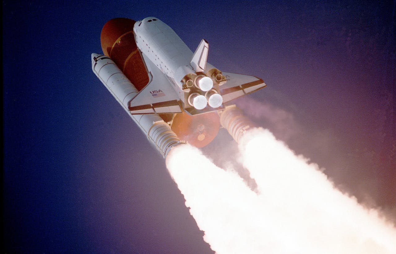 Space shuttle launching into space with text "USA" in the background.